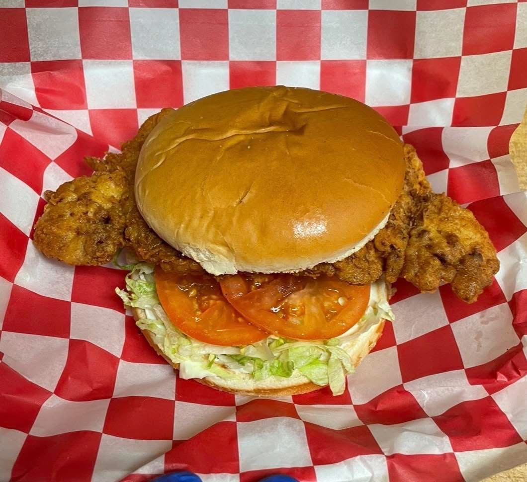 Crispy fried chicken sandwich with tomato and lettuce