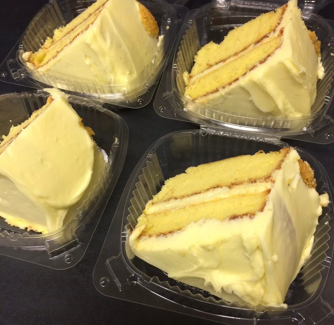 Slices of homemade layer cake with cream frosting