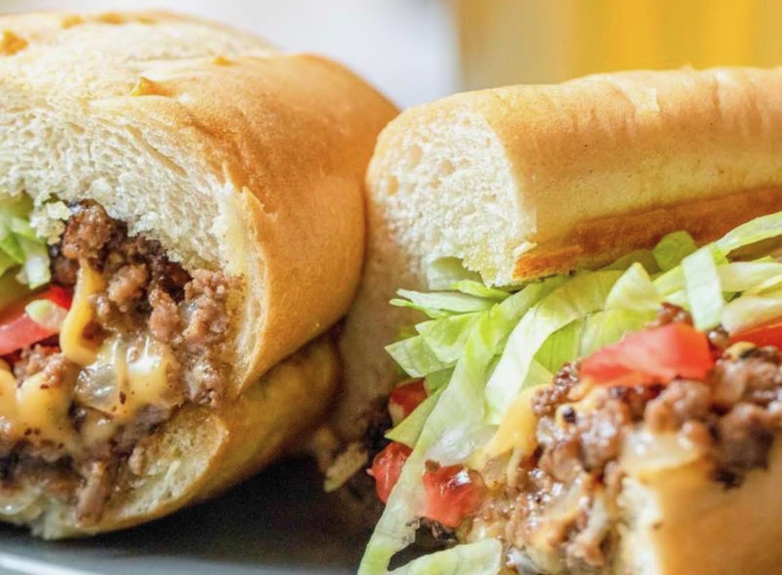 Chopped cheese sub with lettuce, tomato, and melted cheese