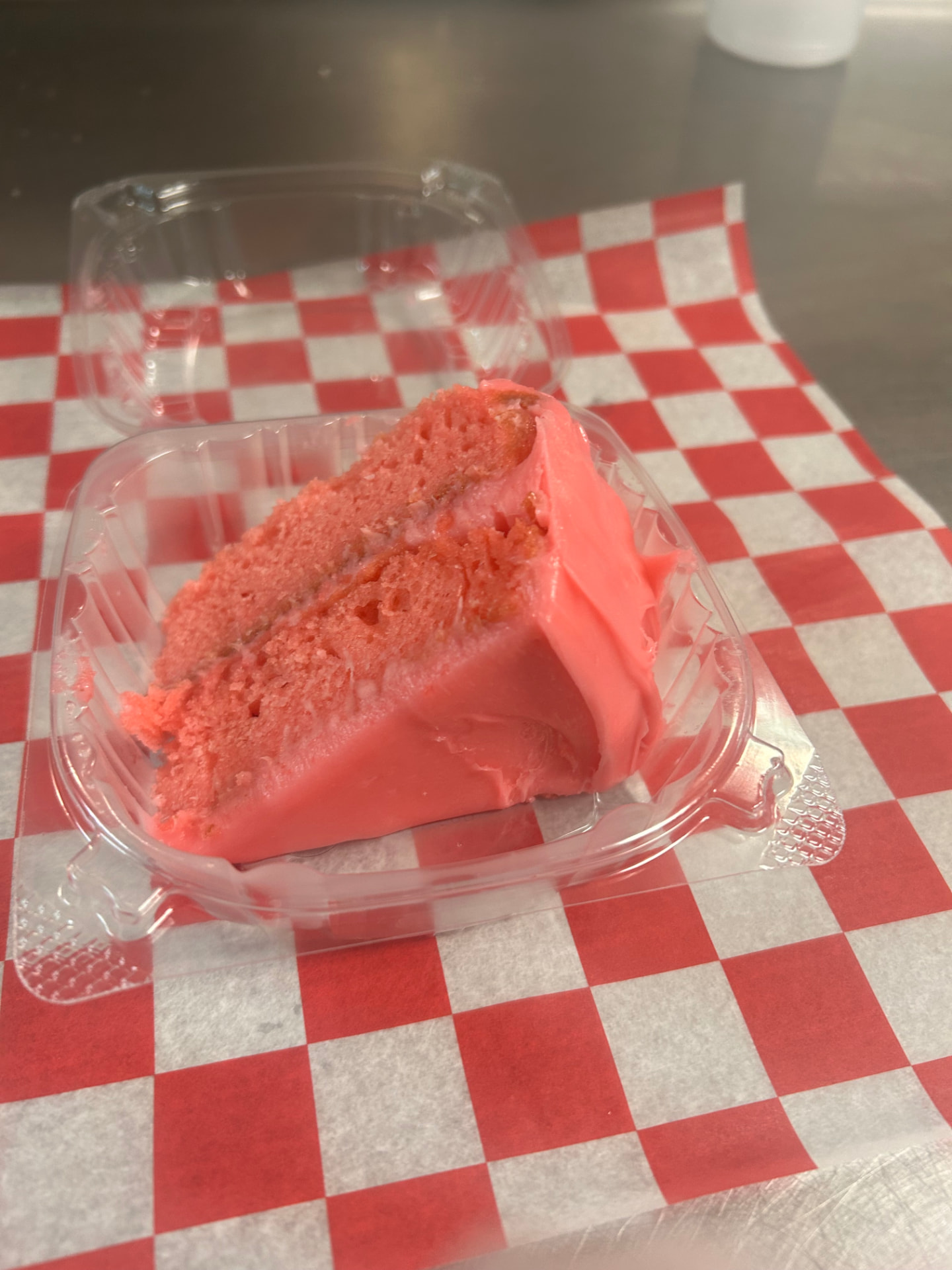 Slice of strawberry cake with pink frosting