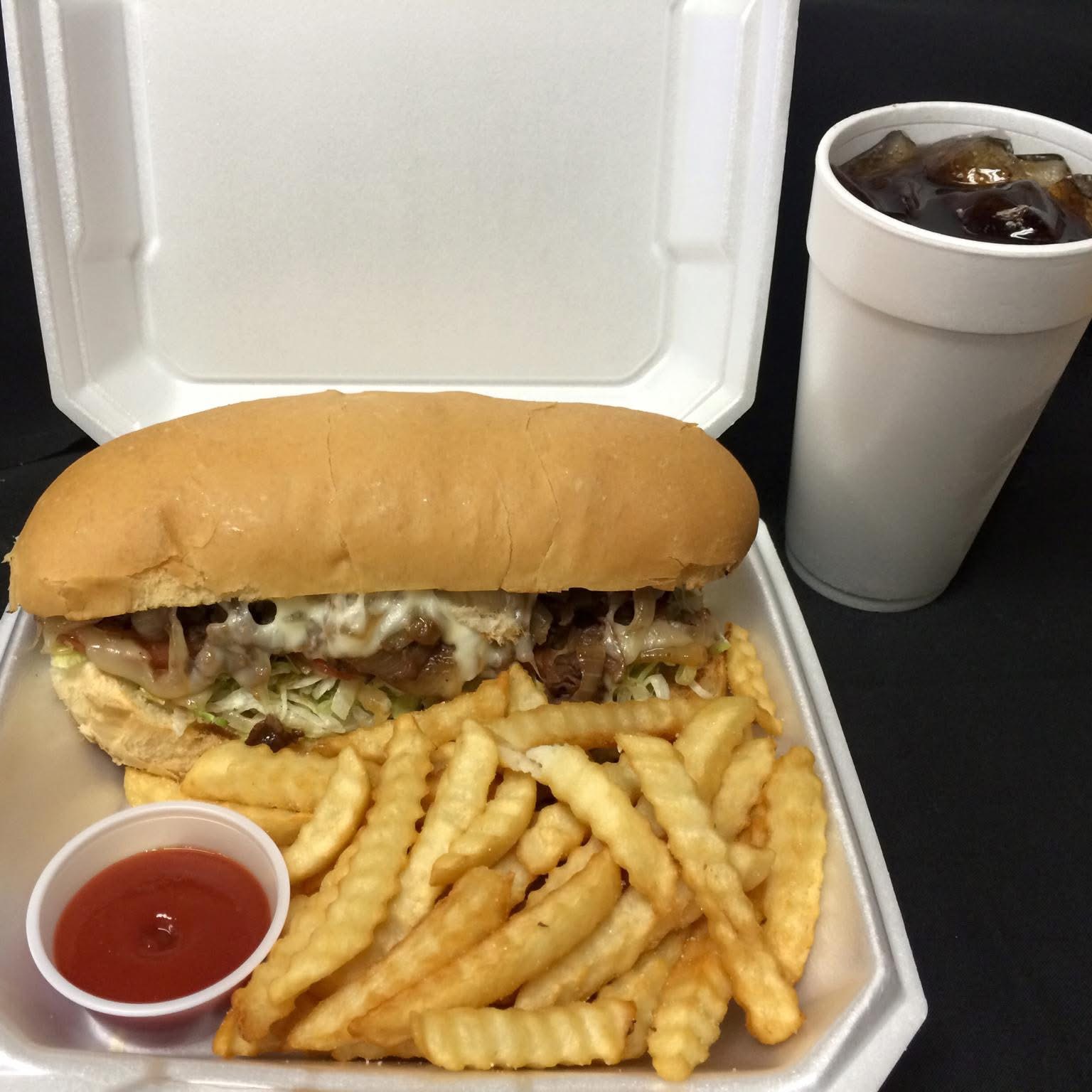 Cheese steak sub with fries and a cold drink